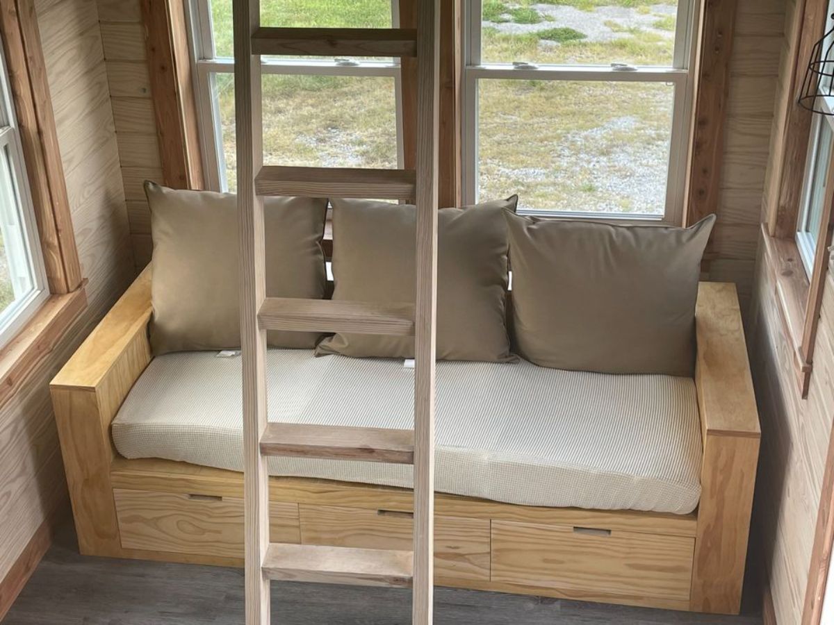 Compact but comfortable living area of 326 sf Spacious Tiny House has a small couch