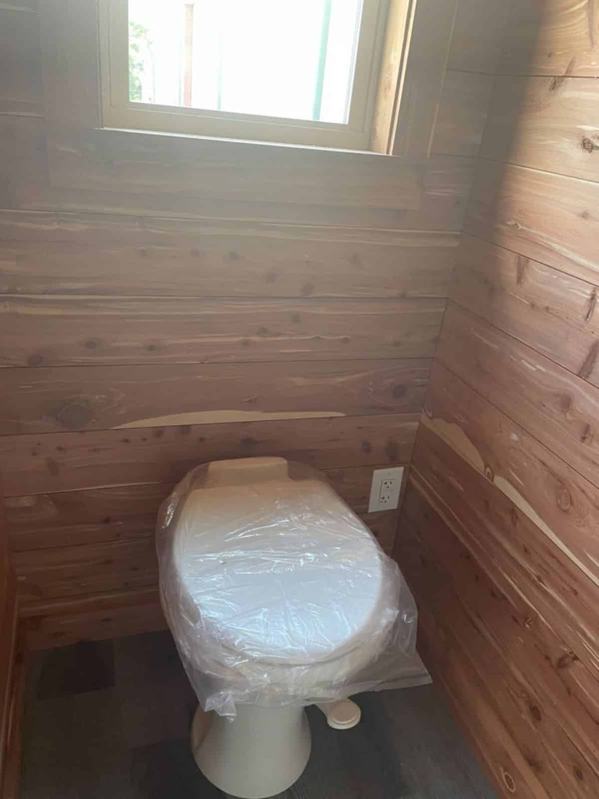 Standard toilet is also installed in bathroom