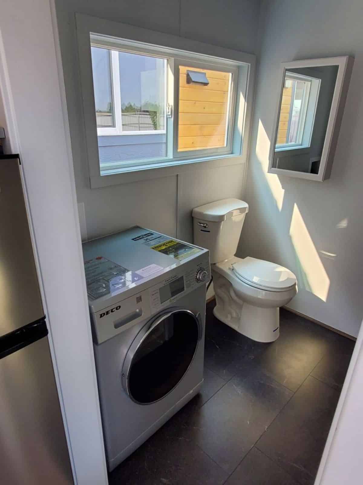 Neat and clean bathroom of Brand-New Tiny Home with washer dryer combo installed already included into the deal