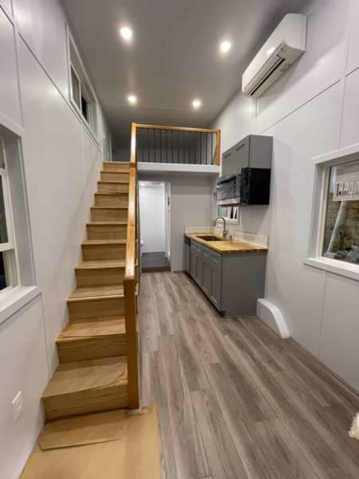 Stairs leading to to loft bedroom of Brand-New Tiny Home and air condition unit is installed included in the deal