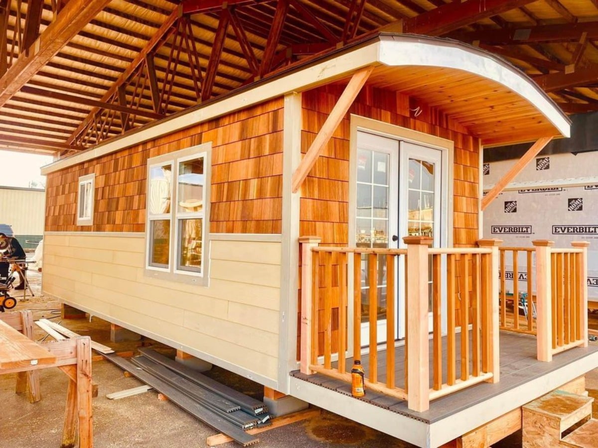 Stunning main door view of Gorgeous Red Cedar Tiny Home and has porch outside it