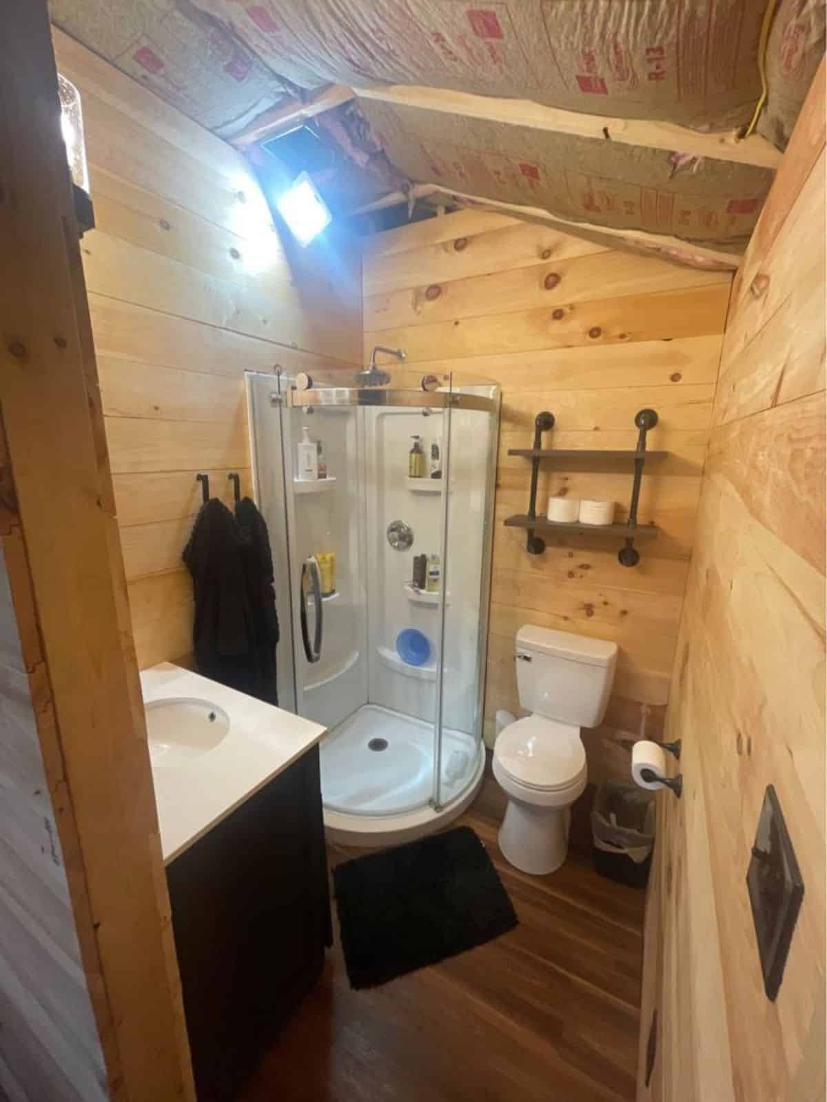 Standard toilet & separate shower area in bathroom of Idyllic Tiny House