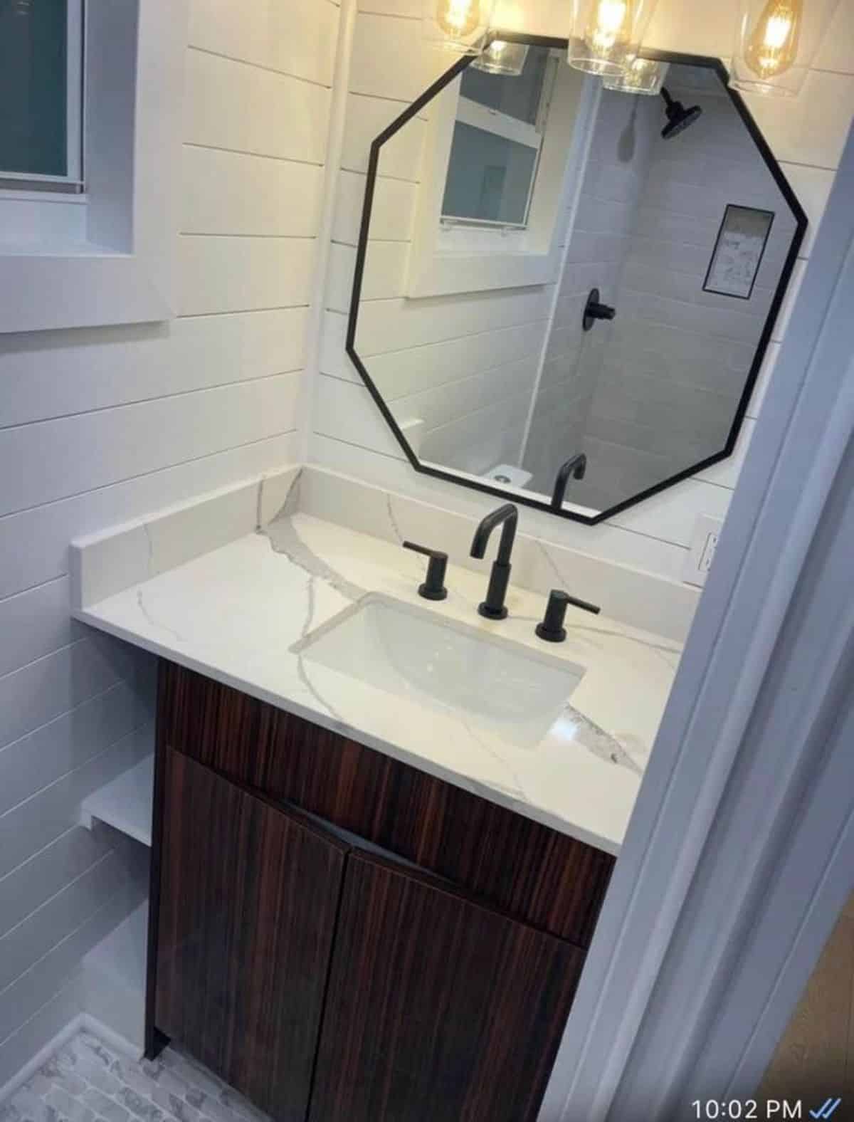 Sink with vanity and mirror in bathroom