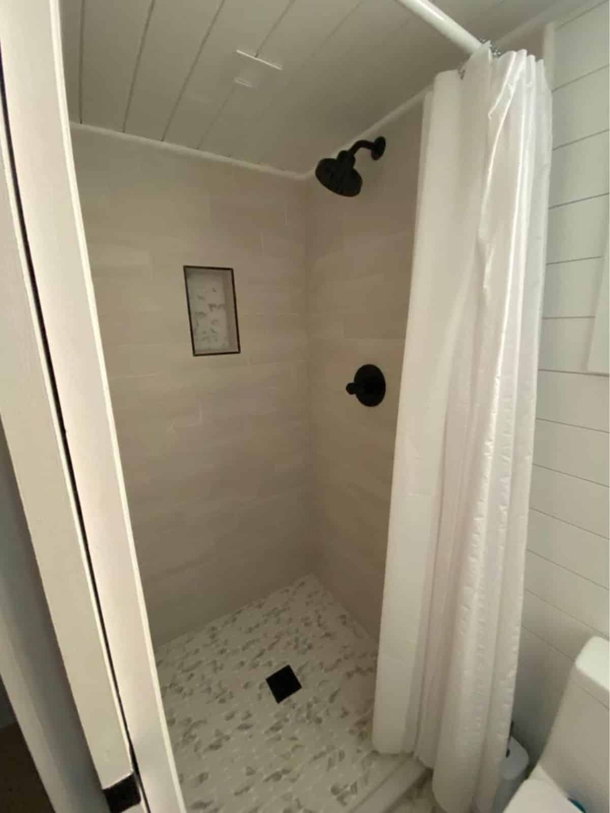 Separate shower area in bathroom of Luxurious Tiny Home