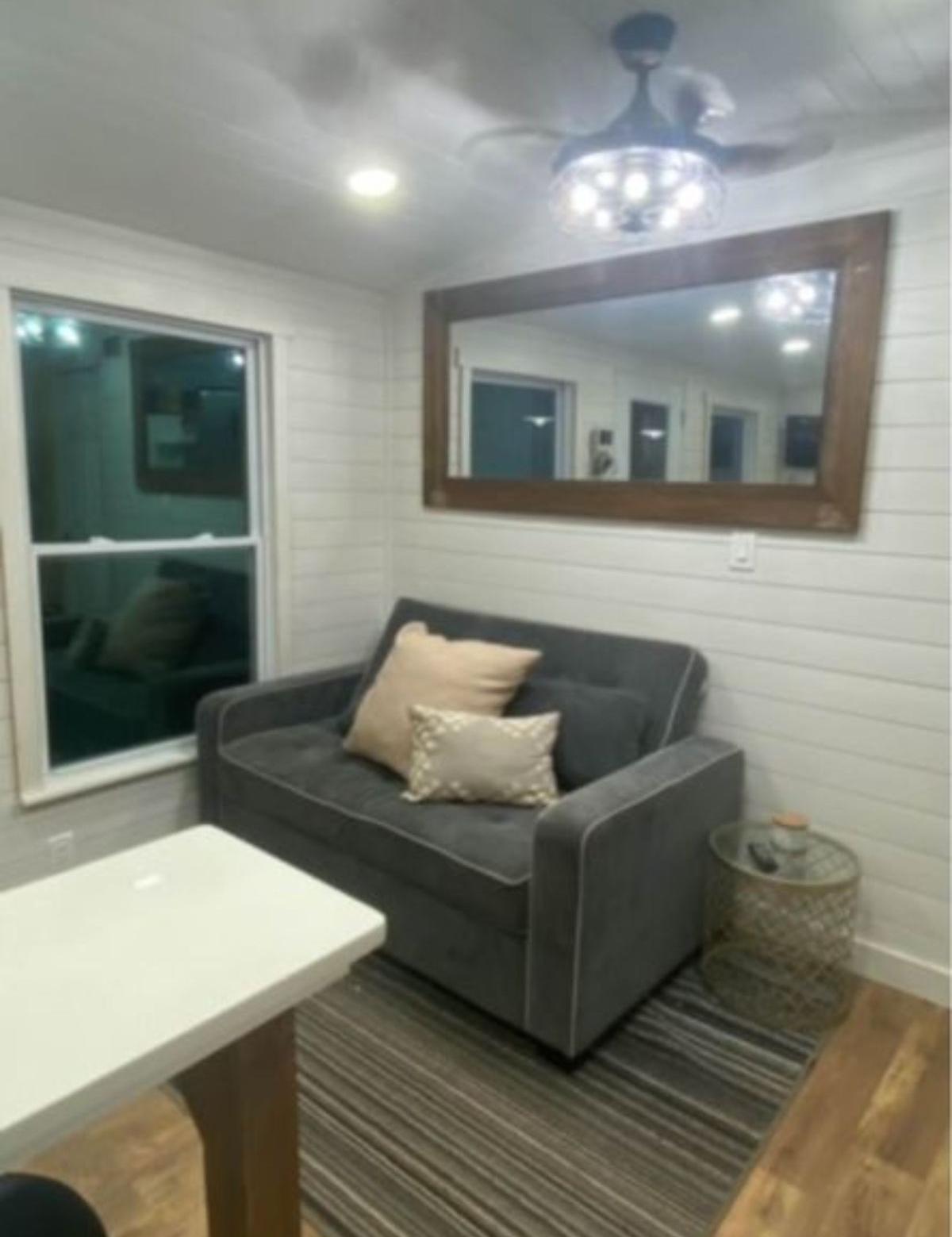 Living room of Tiny Modular Home With 2 Bedrooms has comfortable couch.