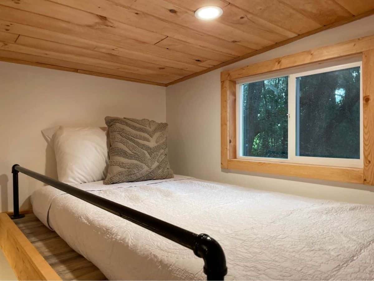 Loft bedroom is above the bathroom sand has a queen mattress and huge windows