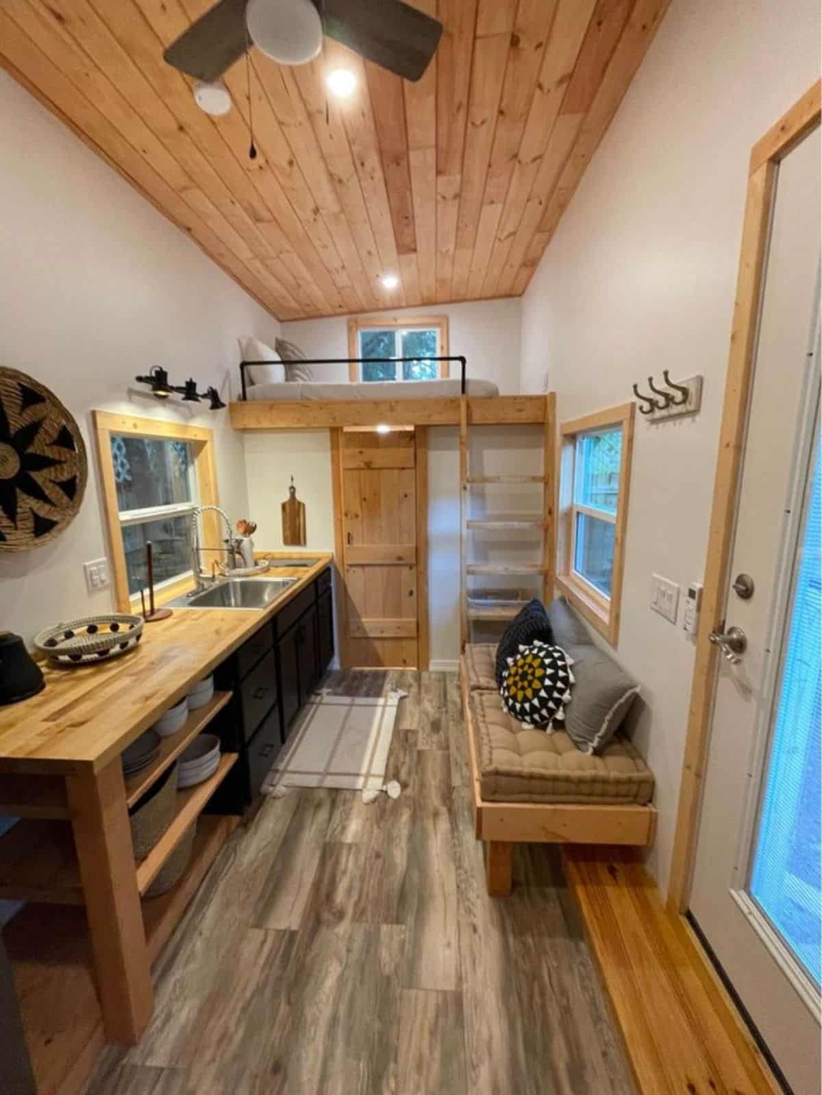 Classic wooden interiors and LED lights installed all over the Towable tiny house