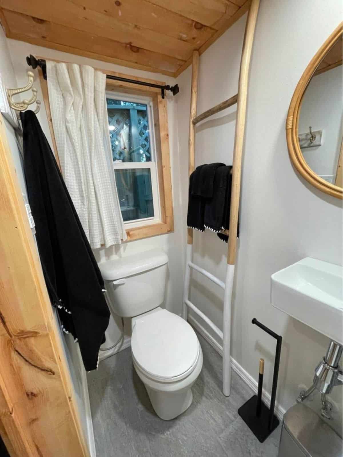 Standard toilet in bathroom of Towable tiny house