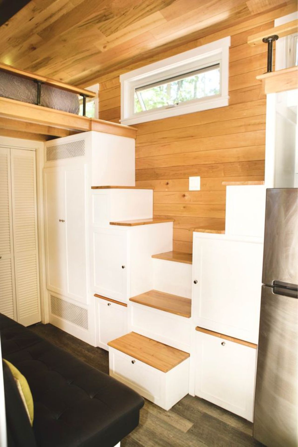 Stylish stairs with storage cabinets underneath leading to both the bedrooms 