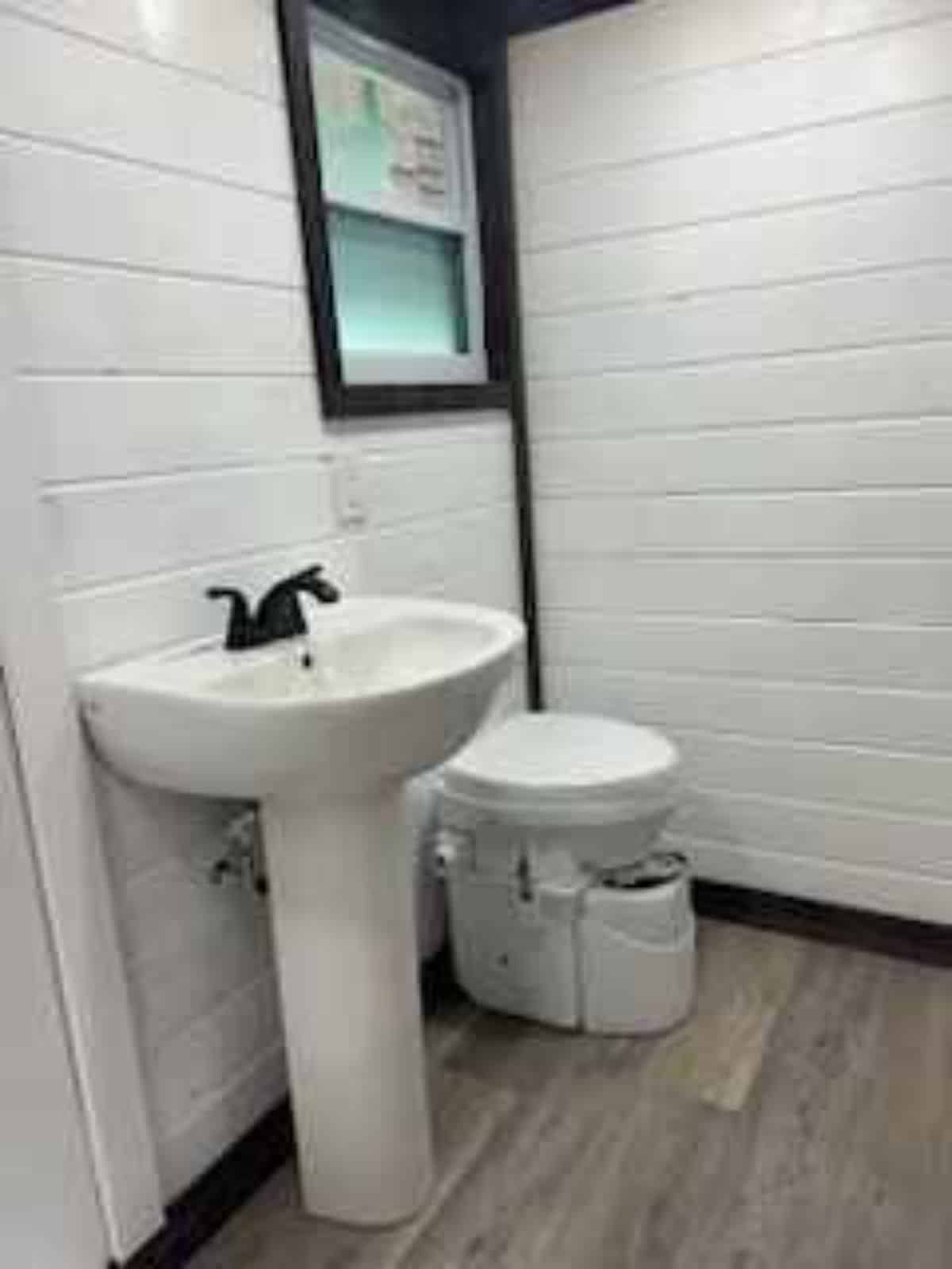 Standard toilet and sink in bathroom of 1 Bed Tiny Home