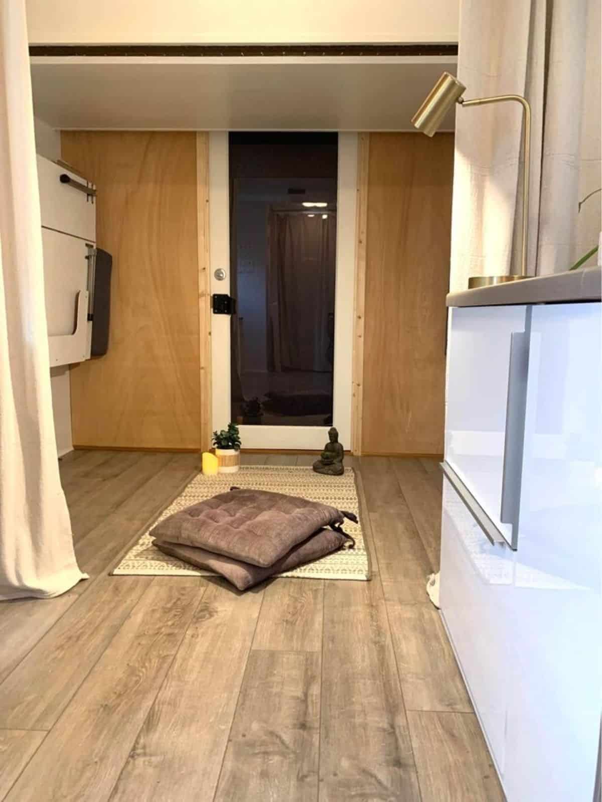 Foldable bed in the living area can be used as additional sleeping area of 20' Compact Tiny House