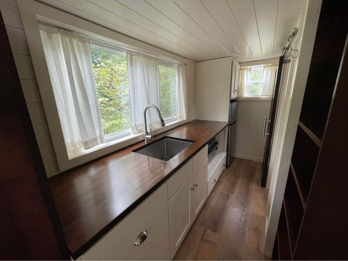 Kitchen of 20’ Modern Tiny Home on Wheels has a huge countertop with all the essentials