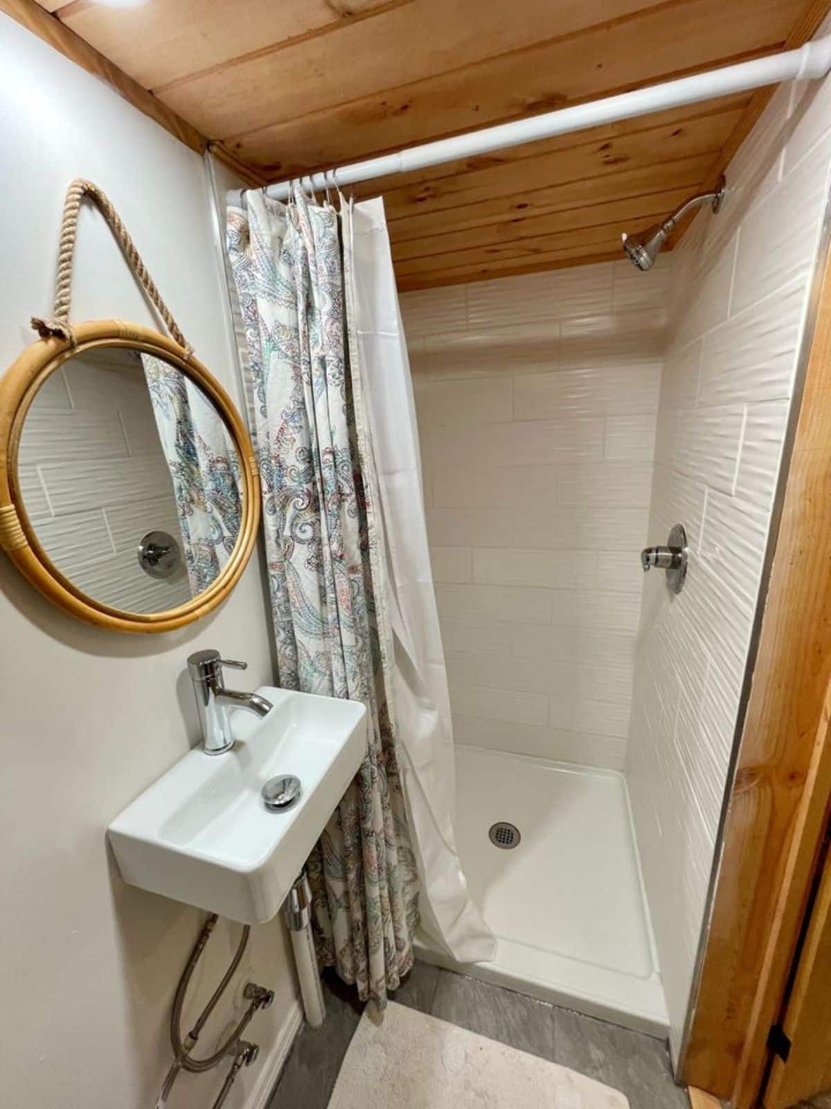 Separate shower area and sink and mirror in bathroom