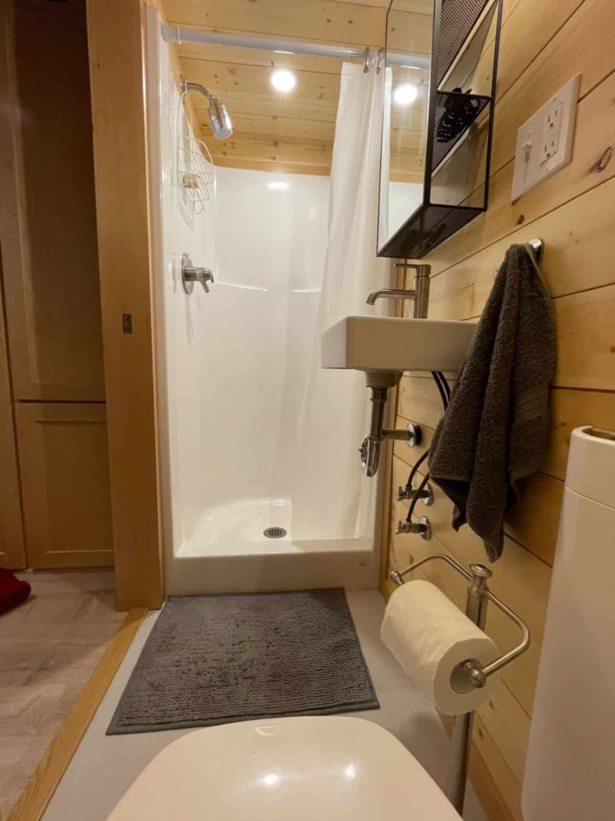Separate shower area plus sink  with mirror in bathroom