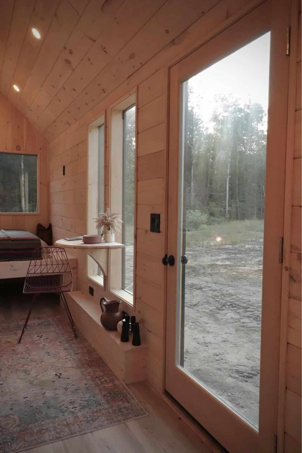 Glass main door plus small dinning area  in 24’ Nordic Style Luxury Tiny House