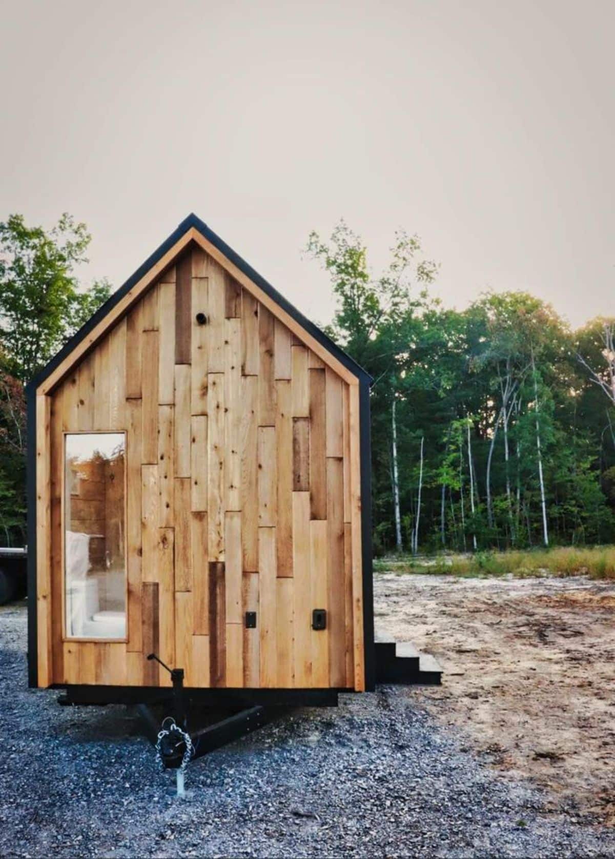 Classic wooden exterior of 24’ Nordic Style Luxury Tiny House