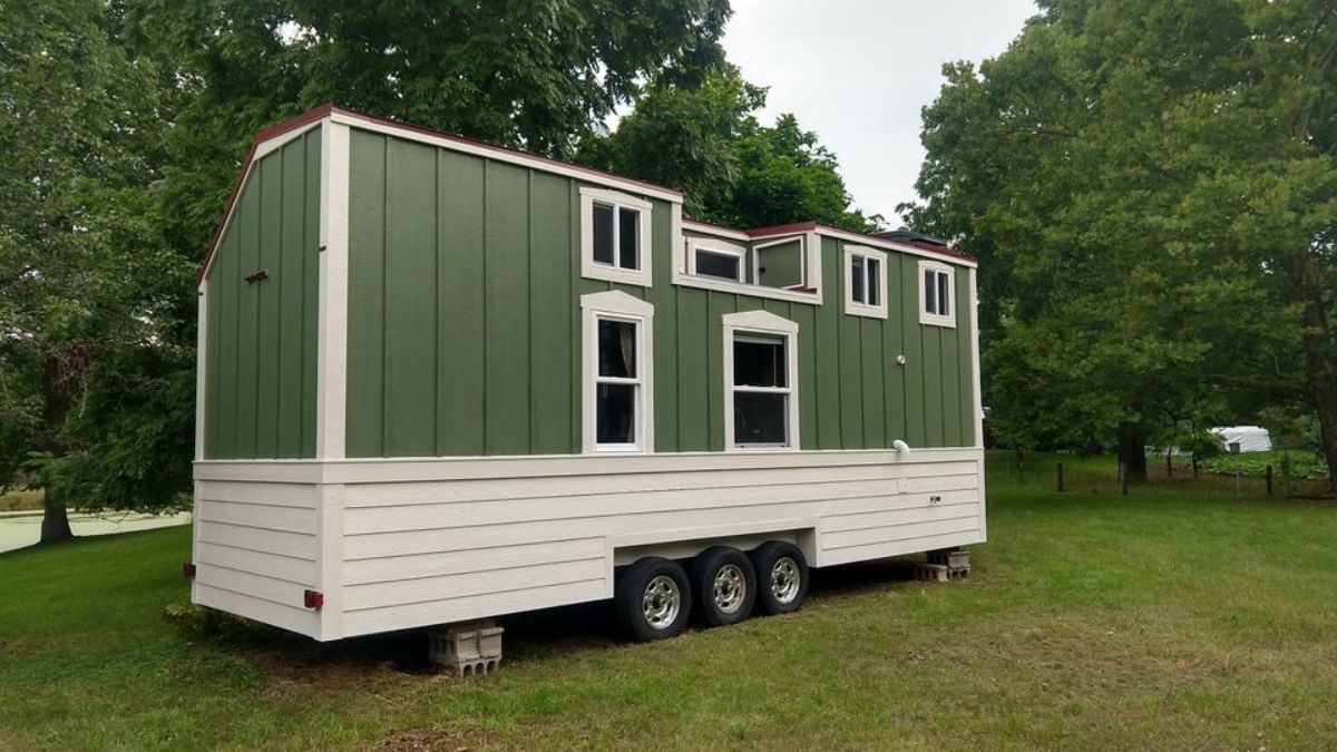 Stunning white and green exterior of 28' Tiny House with Rooftop Deck