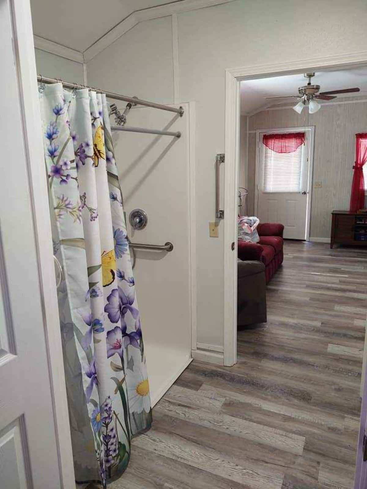 Shower area convenient for a person on wheelchair and living area is seen in the image