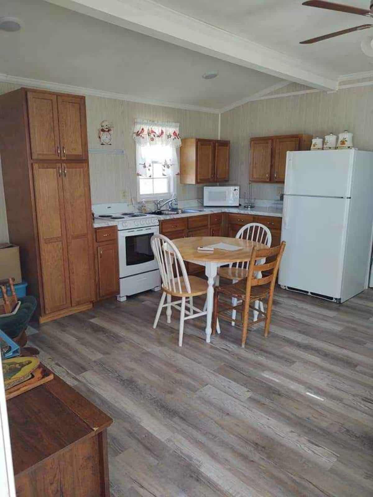 Classic L shaped kitchen table area, dinning area with chairs and spacious living area of 40’ Tiny House