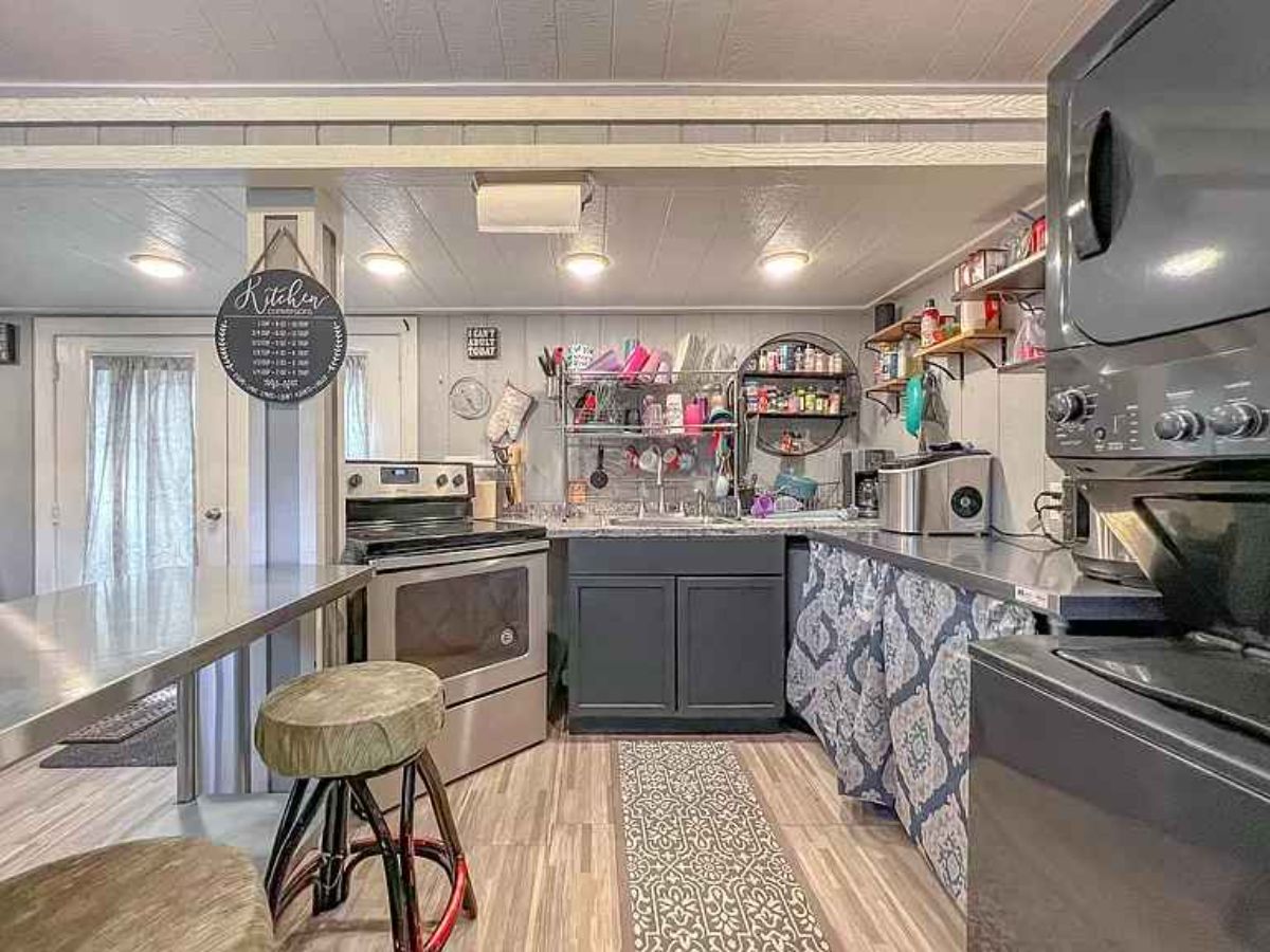 Well organized kitchen area  plus a dedicated dinning area with chairs at Blissful tiny home