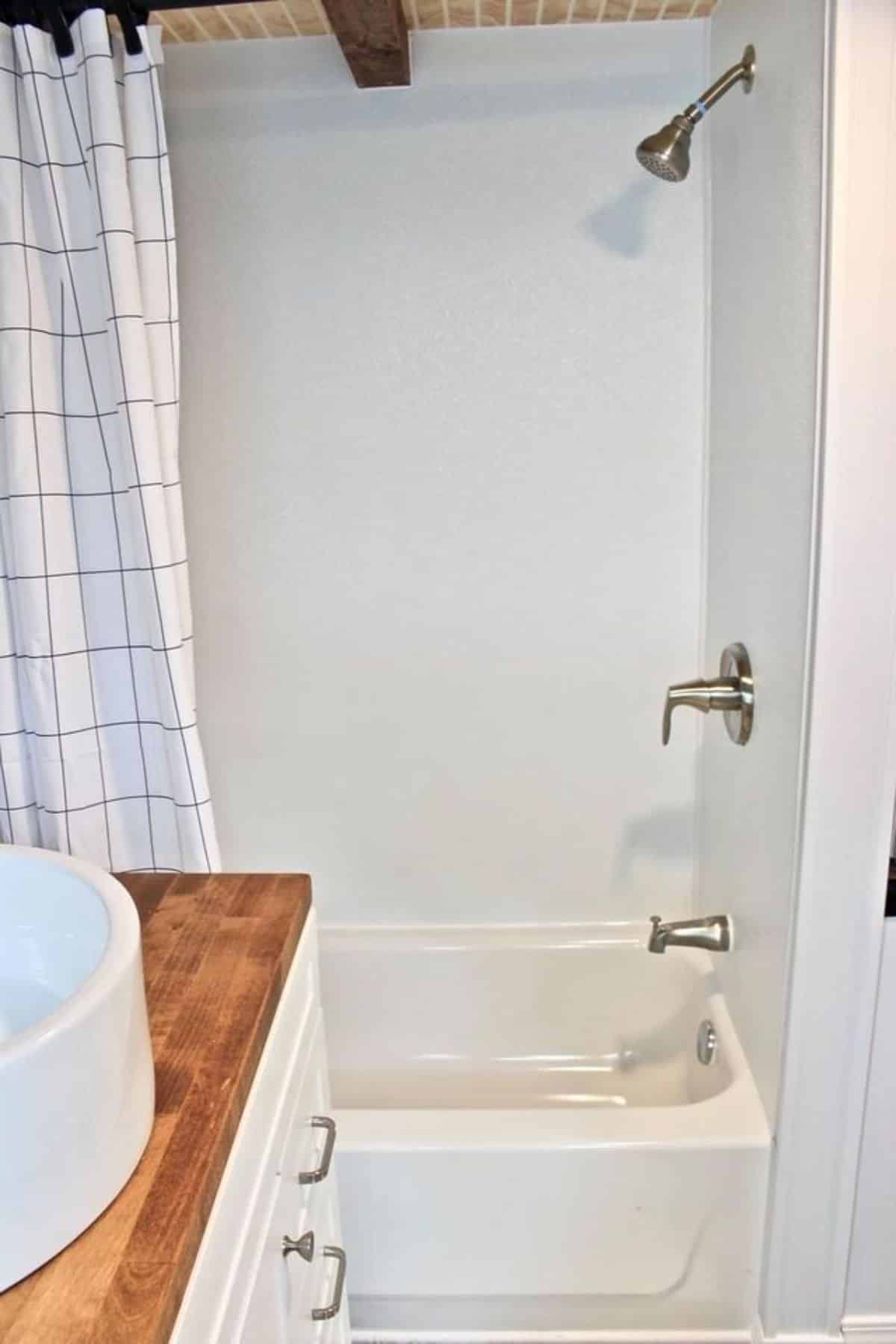 Bathtub is installed in the bathroom of Certified Durable Tiny Home