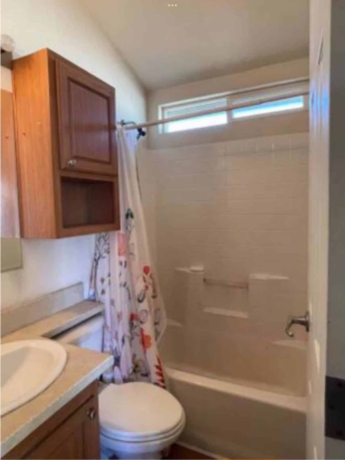 Bathroom has standard toilet, sink with vanity and bathtub