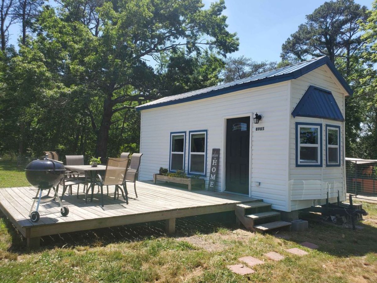 Huge porch with tables & chairs right outside the main entrance of Move-In Ready Tiny Home