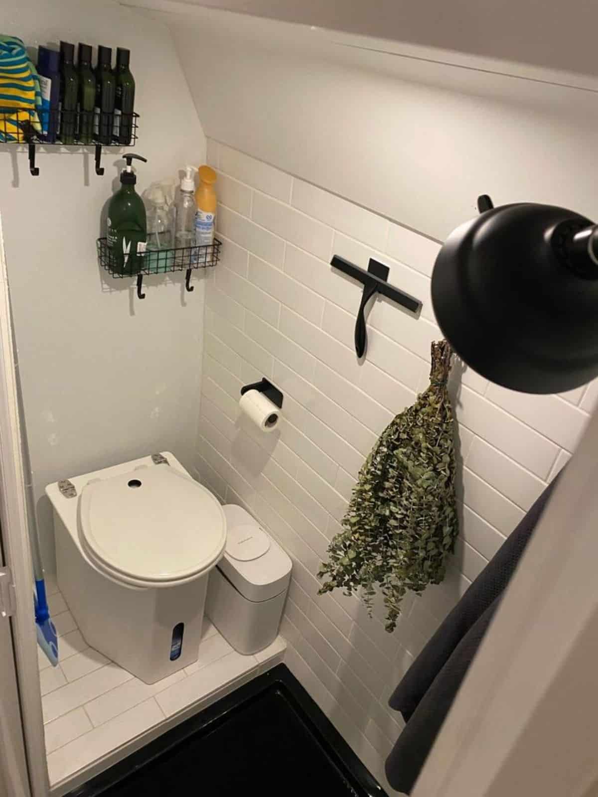 Standard toilet plus shower area in bathroom of Professionally Built Tiny Home on wheels