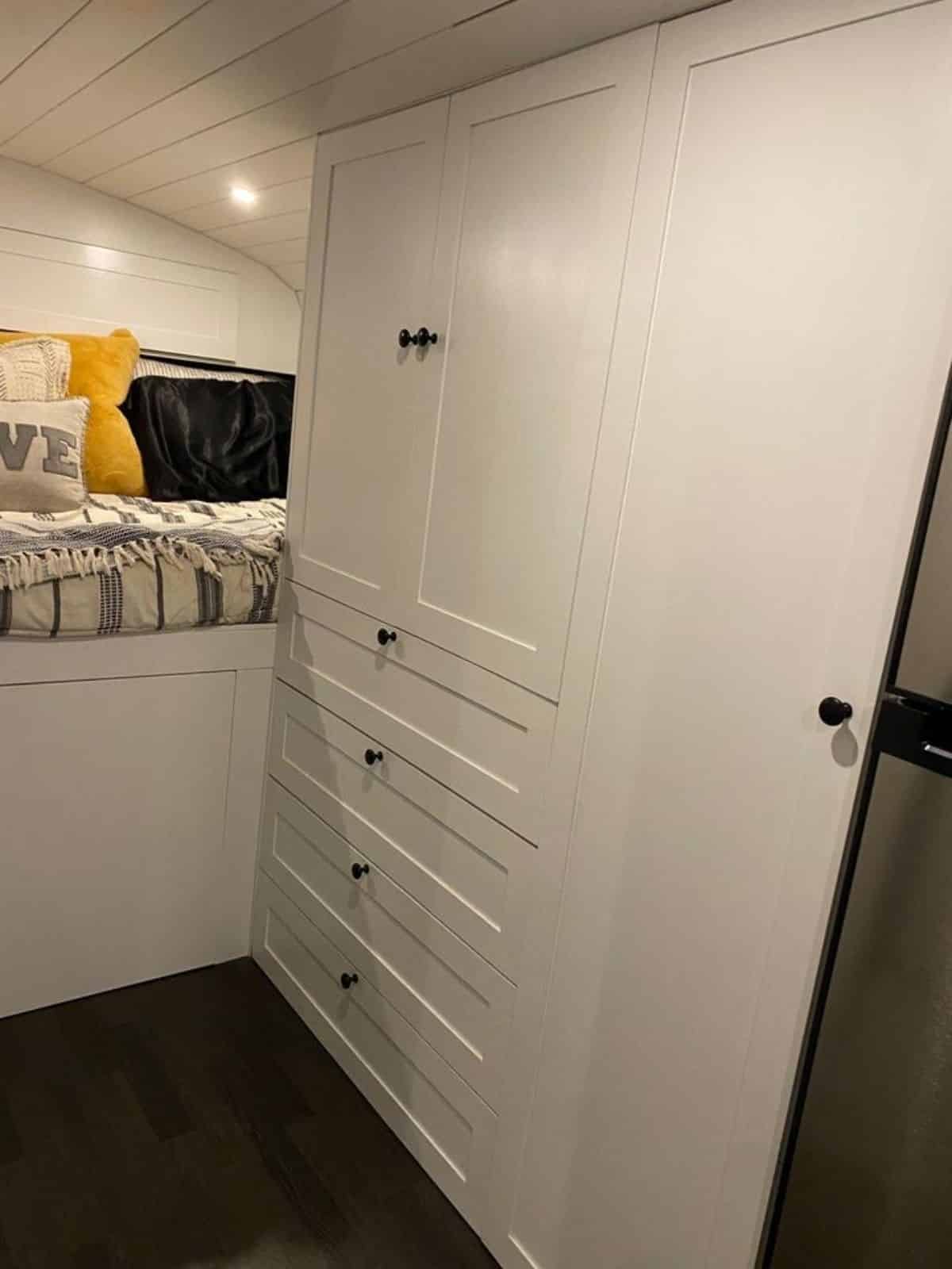 Storage unit is right outside the bedroom has many small cabinets