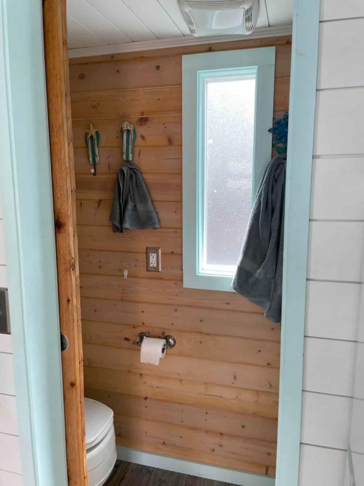 Standard shower and toilet in bathroom of Tiny Beach Cottage