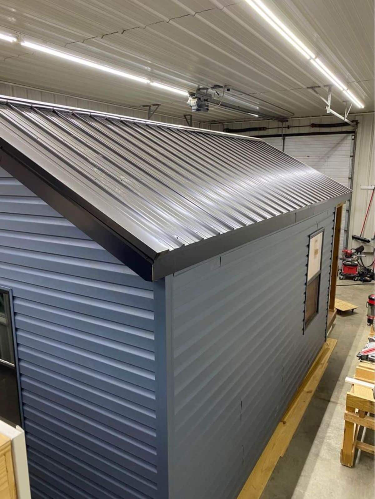 Blue steel roof and outer walls of 20' Budget Friendly Tiny House