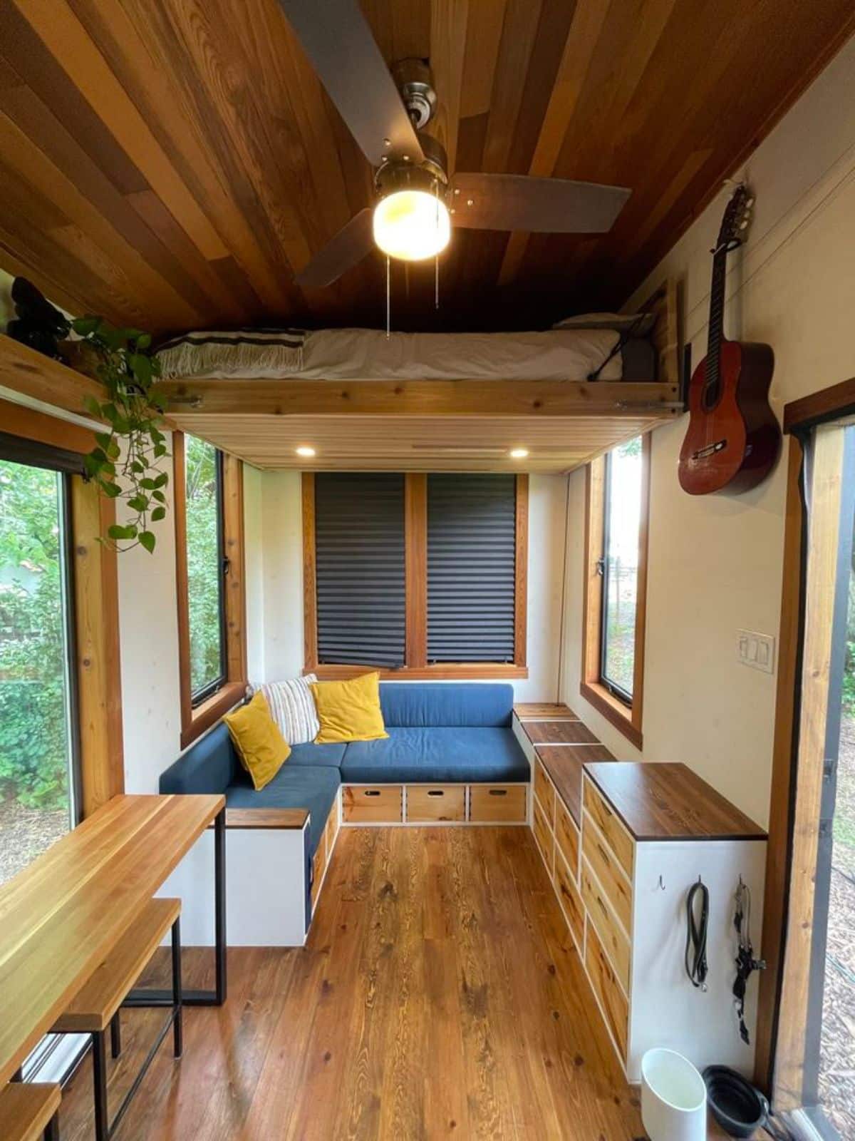 Ceiling fan in living area and stunning wooden interior of 20' Custom Tiny House