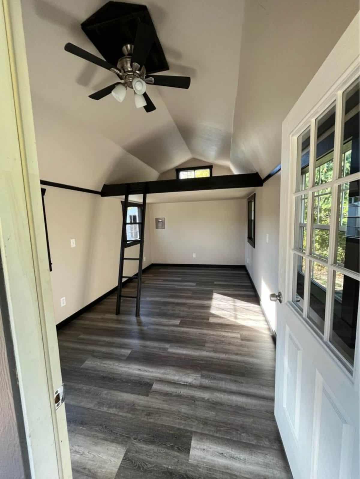 Gray flooring and white walls view from door
