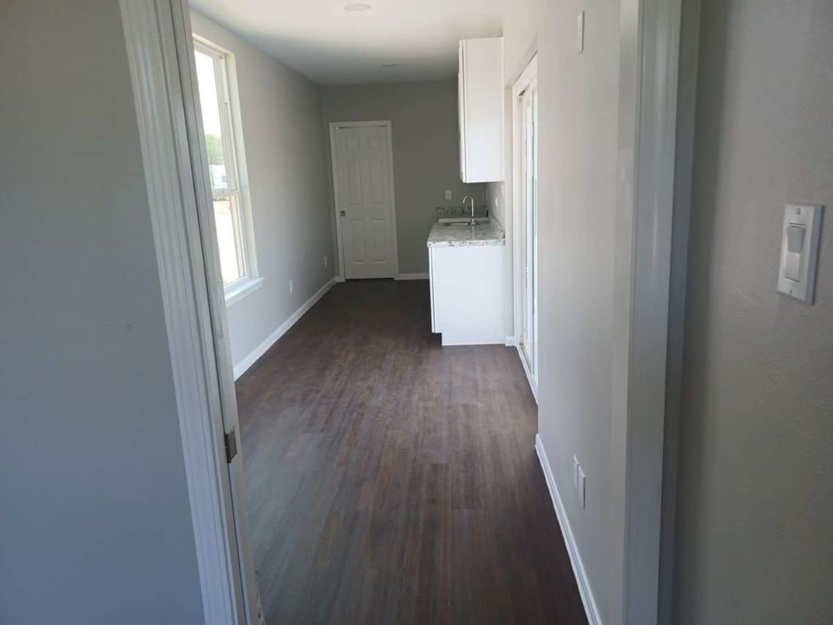 White walls and wooden flooring of 320 sf tiny home