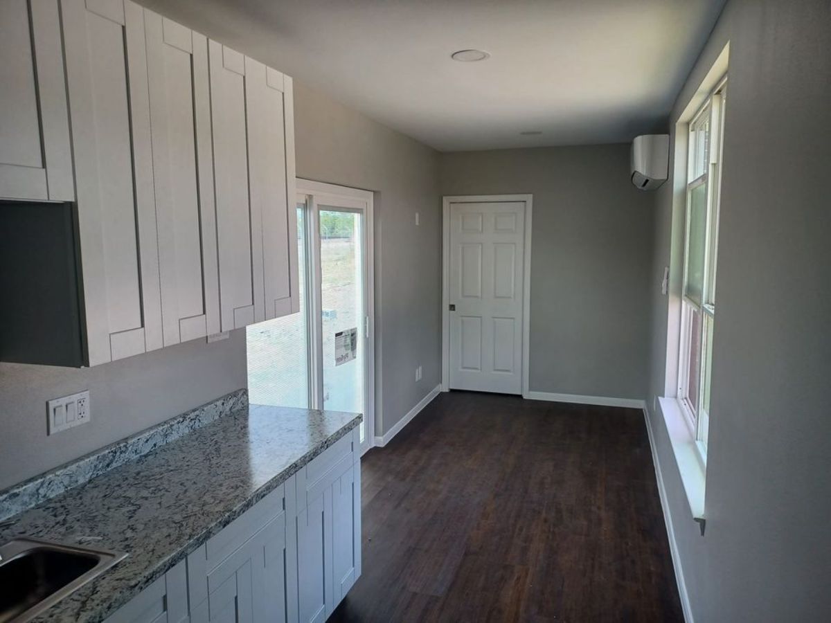 Main living room with main door of 320 sf tiny home