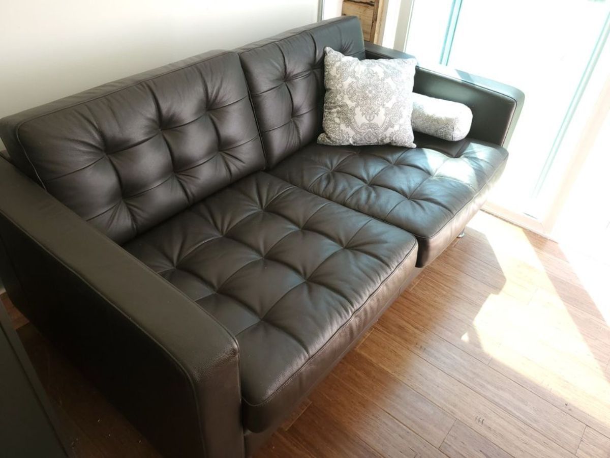 Huge comfortable couch in living area of 40' Luxury Shipping Container Tiny Home