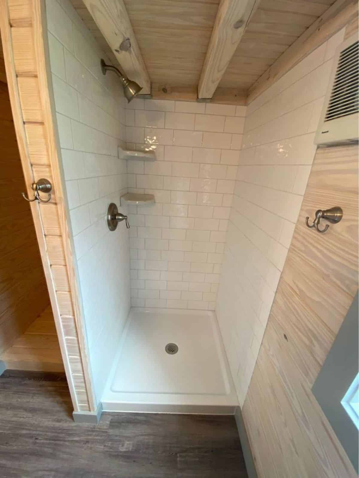 Separate shower area with hookup for washer dryer combo