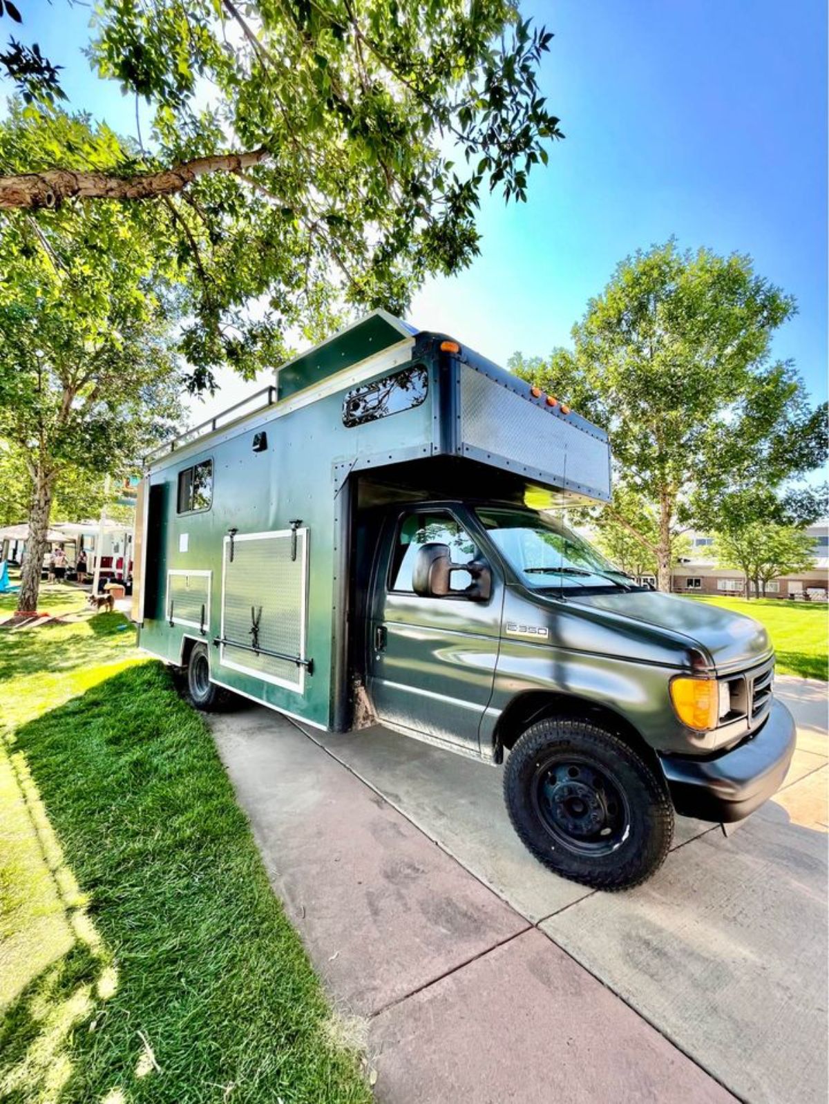 Main entrance view of Modified Ford E-350 Is an Off the grid camper for $100K