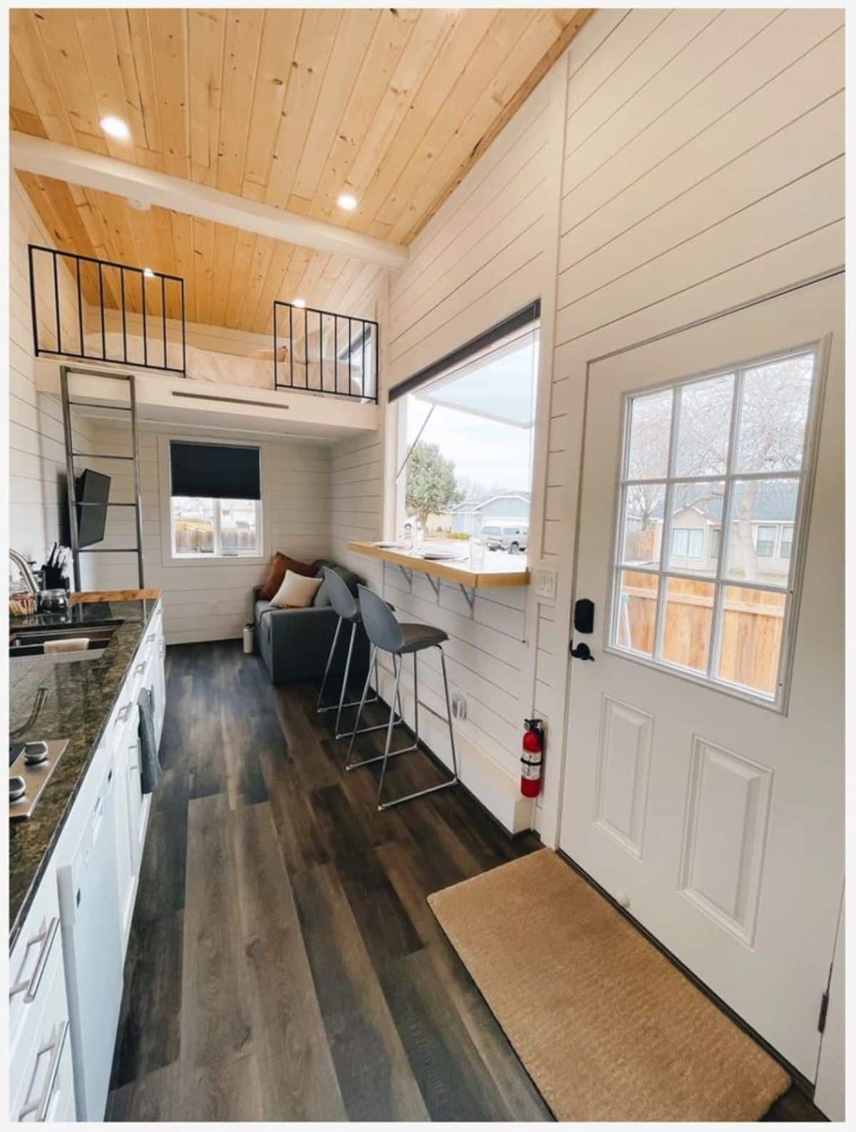 Classy white interiors with dedicated dining area along wide the window of Tiny Home with Financing