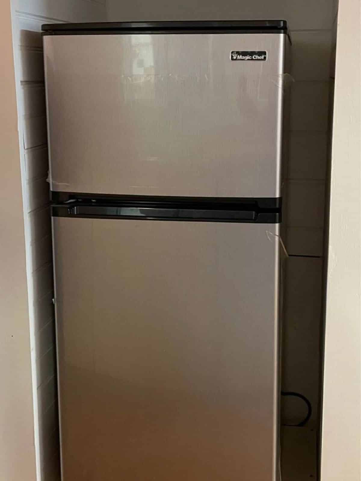 Double door refrigerator installed in kitchen area of 1 Bedroom Tiny House