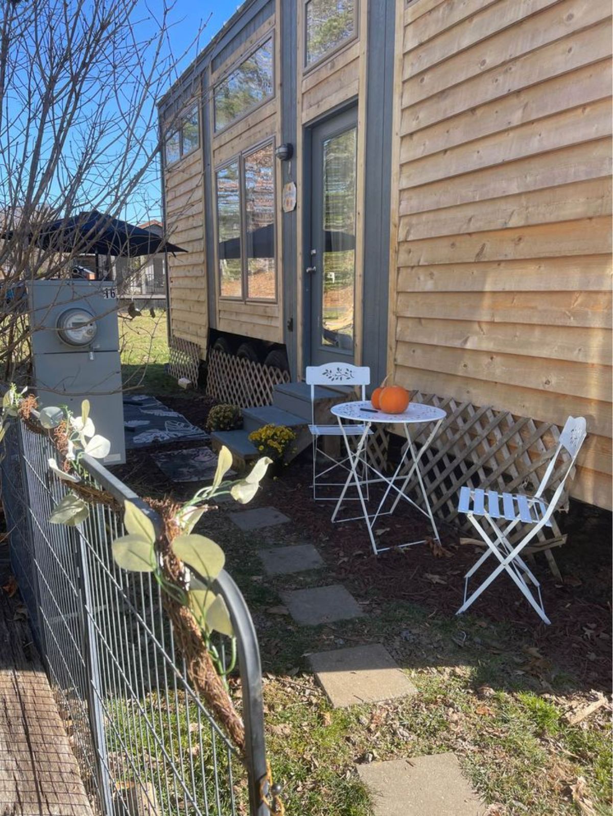 Beautiful table and chair setup outside the main door of 2 Bedroom Tiny Home
