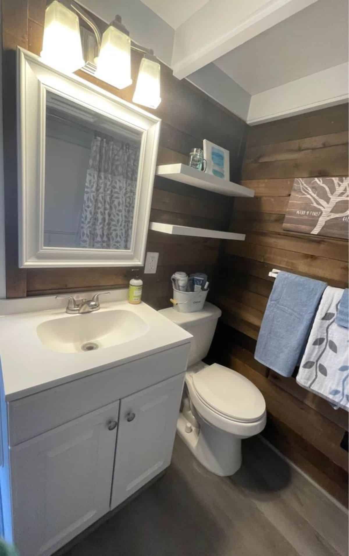 Standard toilet, sink with vanity & mirror