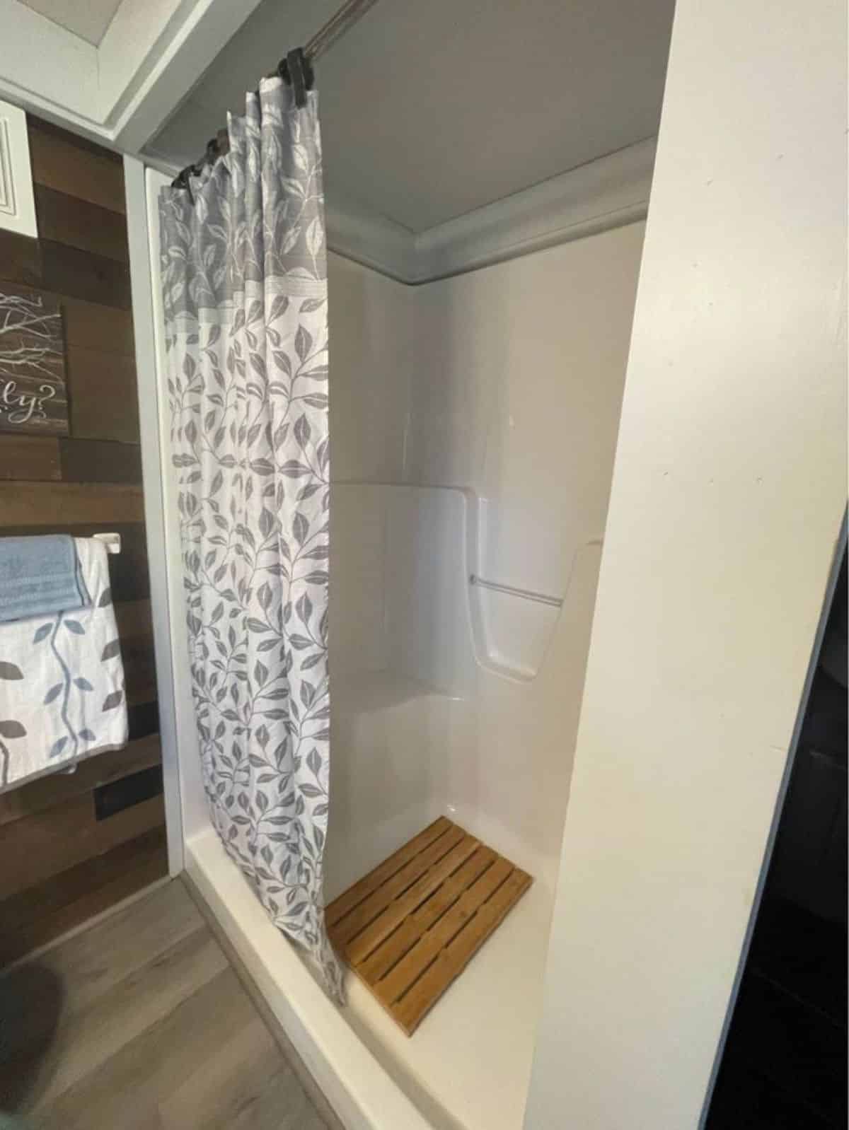 Large shower with built in seat in bathroom