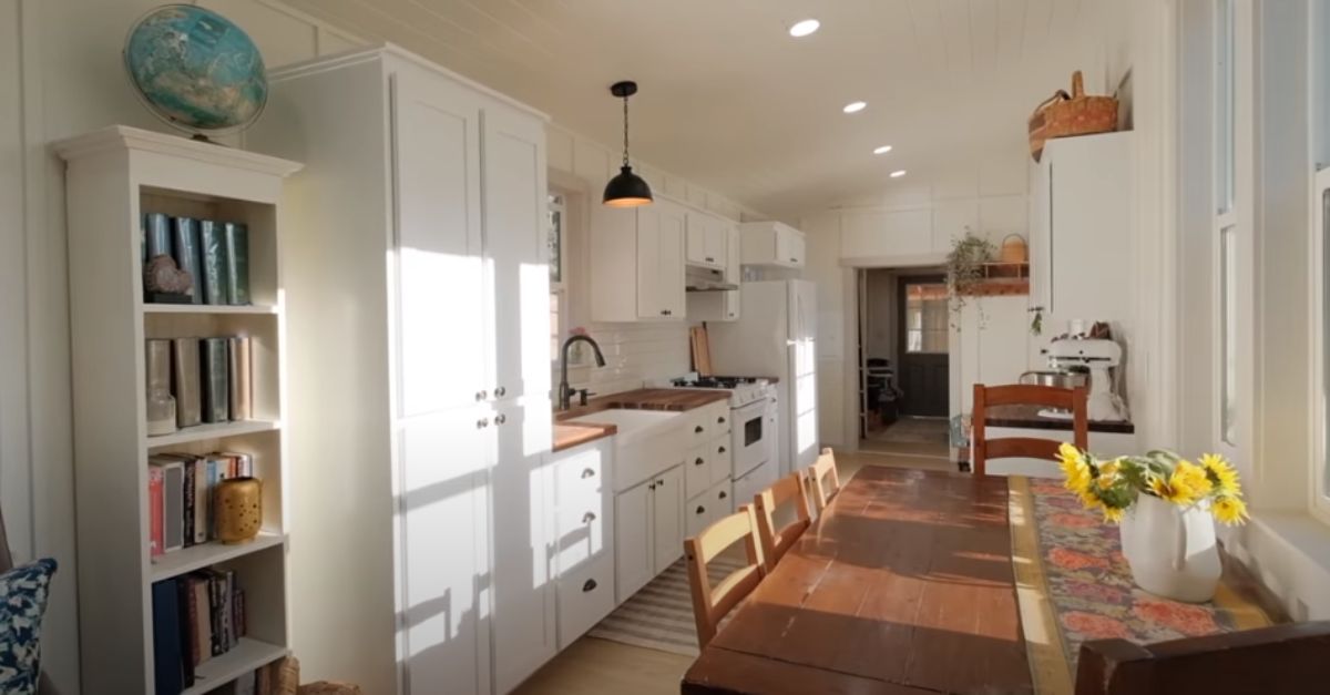 wall of white cabinets with galley itchen