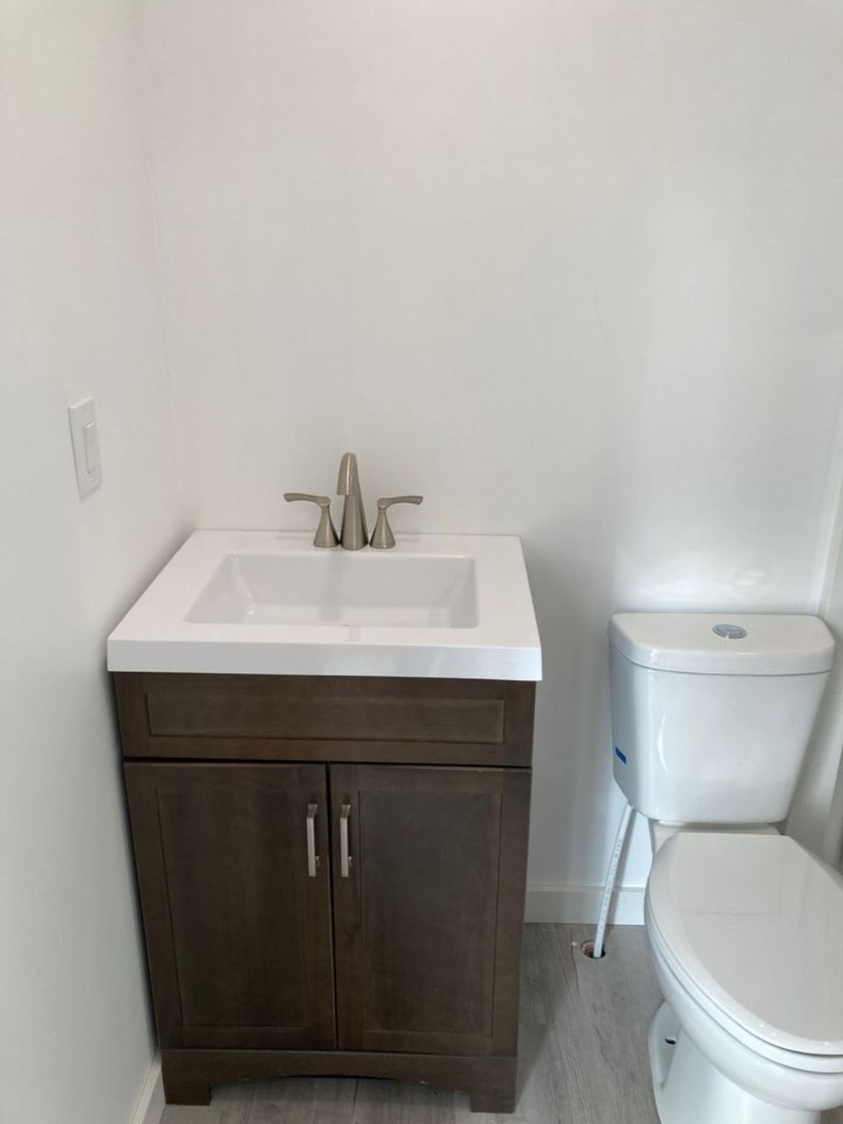 Standard toilet, Sink with vanity in bathroom of 20' Small Container Home