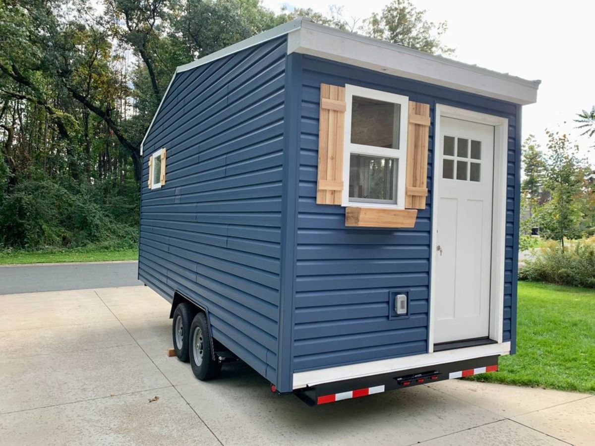 Classic dark blue exterior of 20’ tiny home from side view