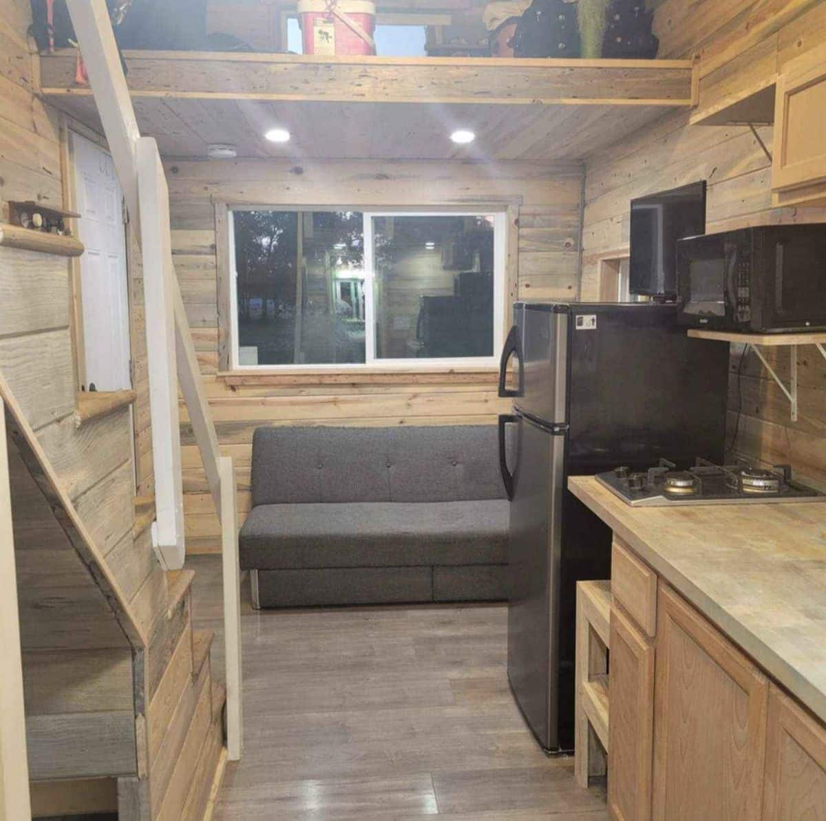 Living area of 20’ tiny house with two lofts