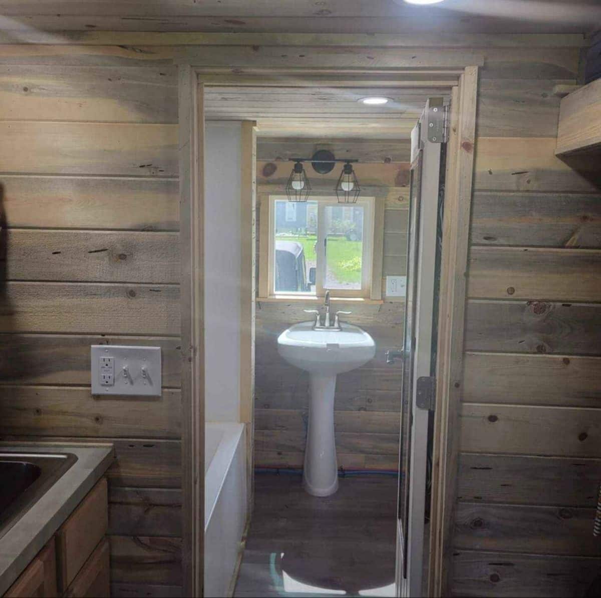 Bathtub in bathroom of 20’ tiny house with two lofts