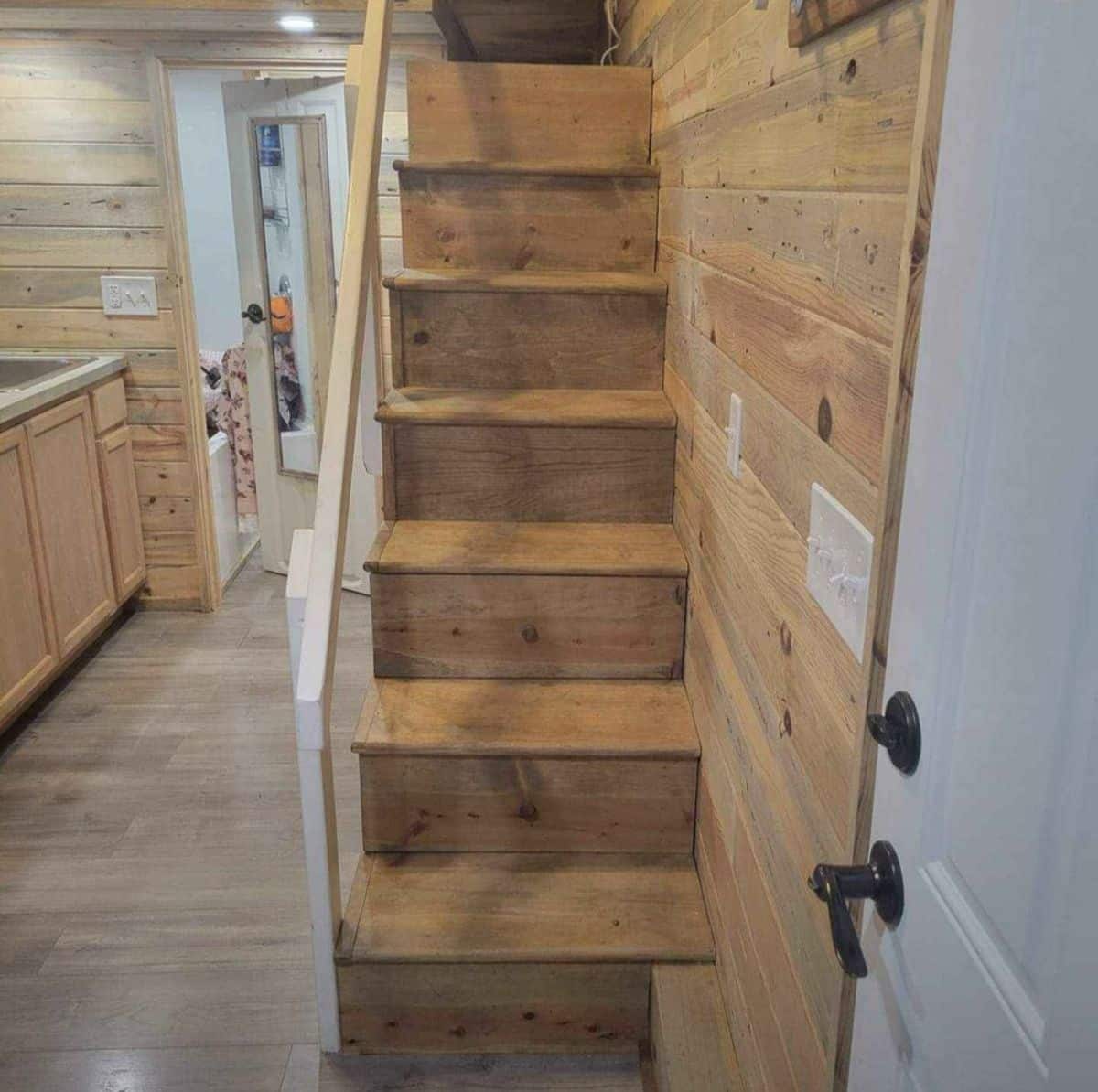 Wooden stairs of 20’ tiny house with two lofts