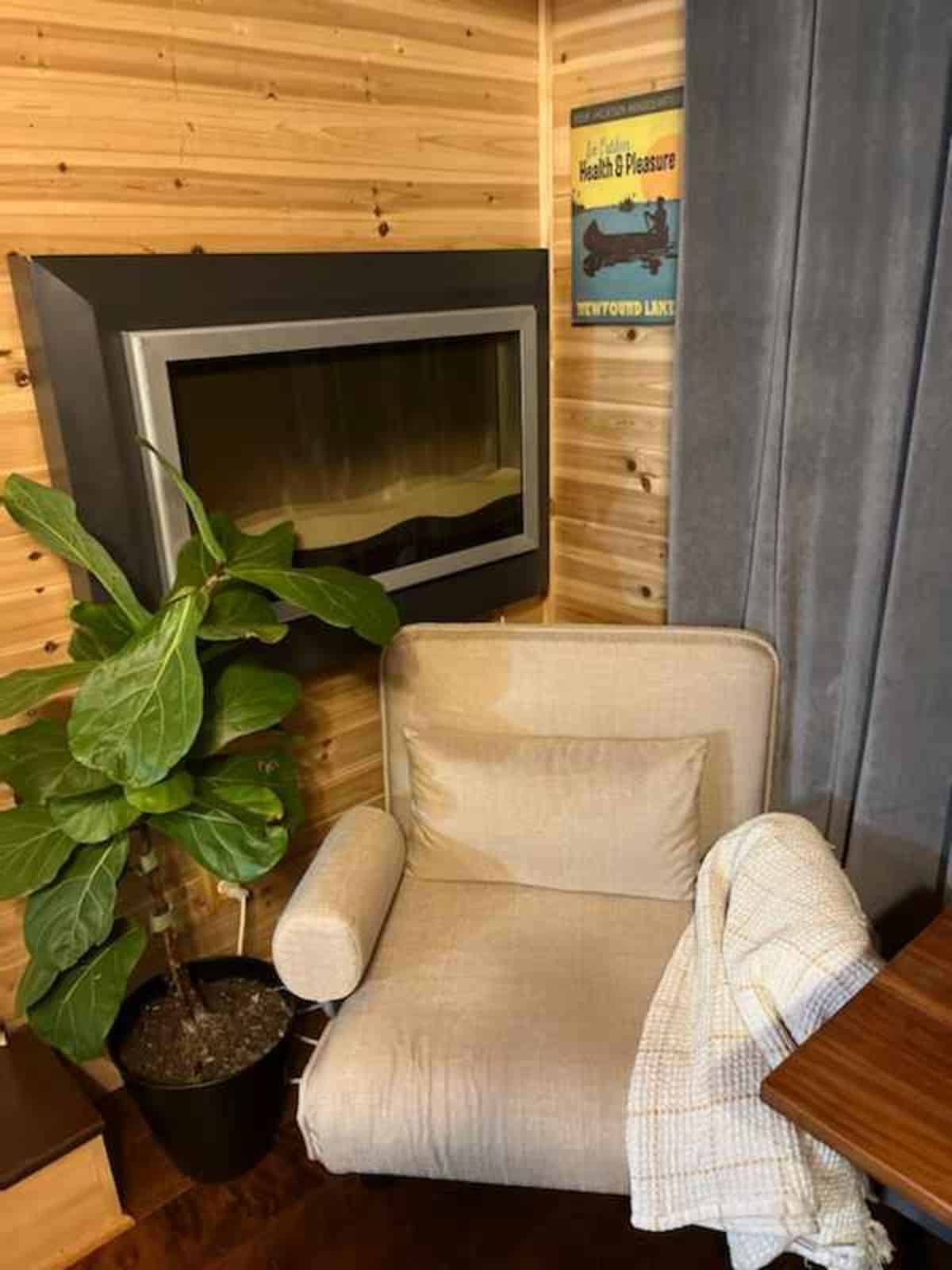 Single seater convertible sleeper chair and fireplace in the living area